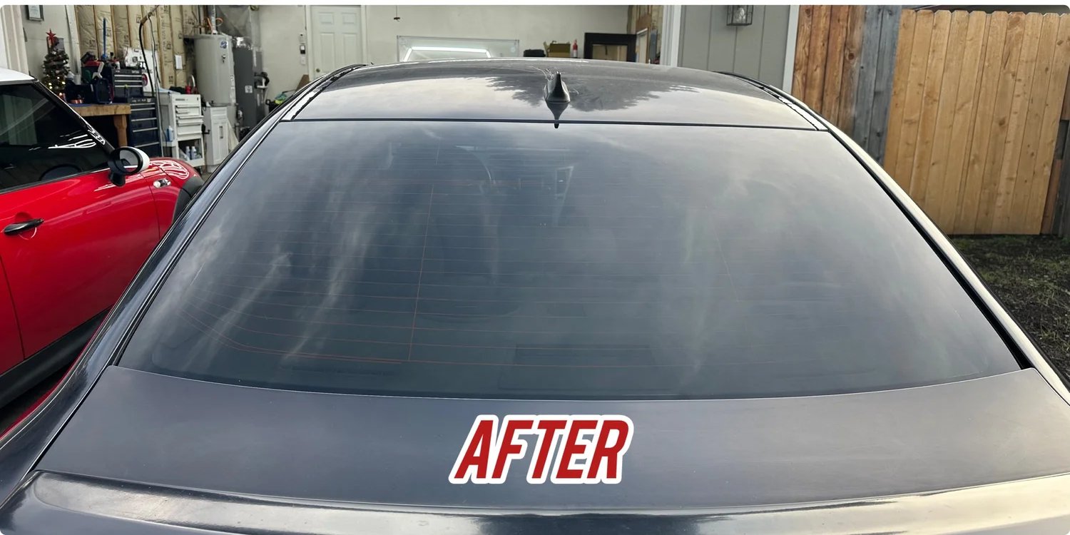 Same vehicle window with clean glass after professional tint removal