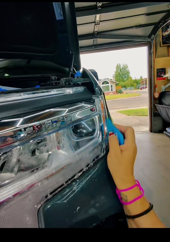Paint protection film being fitted around a Chevy Silverado front end