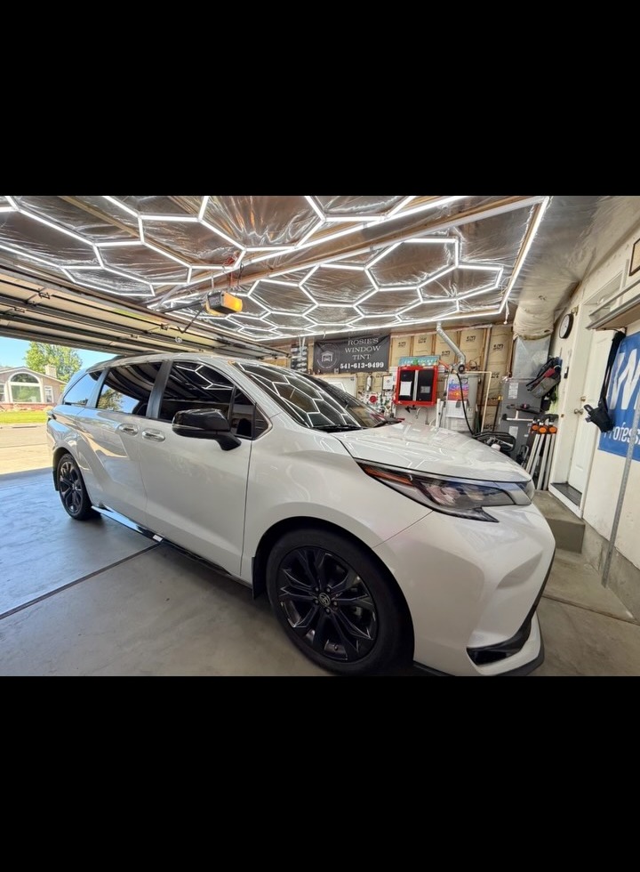 White Toyota Sienna XSE with full ceramic window tint inside Rosie's Medford studio
