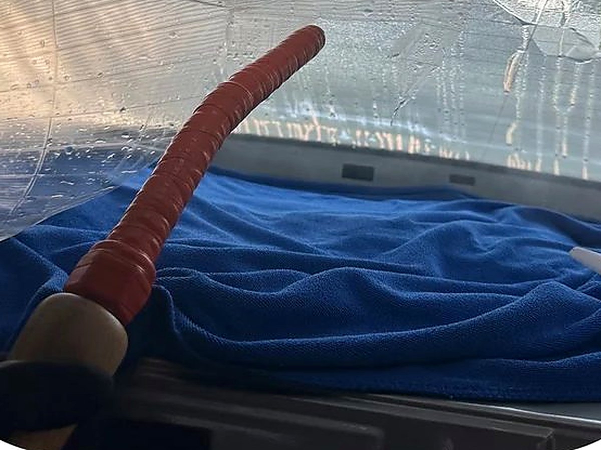 Steam tool being used to remove old film from a windshield